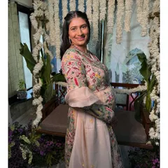 A beautiful portrait of the mom-to-be. Her makeup is soft and pretty, complementing her intricately embroidered pastel outfit.
