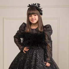 A closer look at the luxurious feather and sequin detailing on the bodice of our black ball gown.