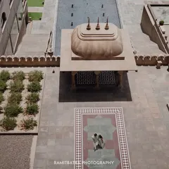 An aerial drone shot capturing the grand scale of the Fairmont Jaipur courtyard as the couple shares an intimate moment.