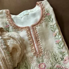 This elegant ensemble, crafted from pure silk chanderi, was part of a mother-daughter festive combo. It showcases a harmonious blend of machine and hand embroidery, perfect for creating coordinated family looks.