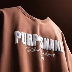Another angle of the brown t-shirt, shot to emphasize the three-dimensional quality of the white printed text.