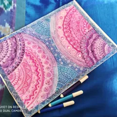 This is my 'Galaxy Mandala' series, where I blend intricate geometric patterns with the colors of deep space. Each section is carefully detailed with fine-line markers, transitioning from cosmic blues to vibrant purples and pinks to create a sense of depth and wonder.