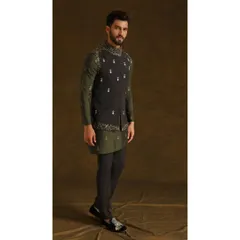 The 'Vedik Vigyaan' ensemble, featuring an olive green asymmetrical kurta paired with a dark grey embroidered bandi jacket. This look is a perfect blend of traditional aesthetics and modern design.