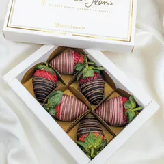 Our elegant gift box of six chocolate-coated strawberries, featuring a mix of milk and dark chocolate with decorative drizzles.