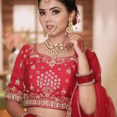 An elegant bridal portrait focusing on the bride's makeup, jewelry, and the fine embroidery of her wedding blouse.