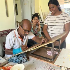 A duplicate image showing the father-daughter team at work, bridging the gap between the traditional artist and our valued clients.