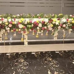 A beautiful floral arrangement designed to adorn a table or ledge, adding a touch of elegance to the venue for a half saree function.