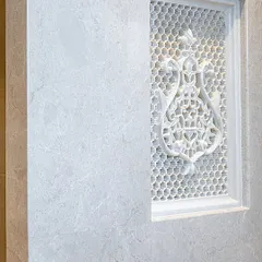 A closer look at the handcrafted lattice panel. The intricate design allows light to filter through while maintaining privacy. It’s a perfect example of how historical design elements can be adapted for modern living, adding texture and artistry to a clean, contemporary space.