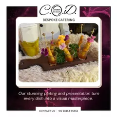 Attention to detail is at the core of our service. Here, crispy appetizers are served in individual shot glasses with dipping sauce, garnished with edible flowers, and presented on a rustic wooden board for an elegant and convenient pass-around snack.