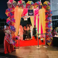 Here is the same vibrant umbrella arch entrance seen at night. With proper lighting, the colors pop even more, creating a festive and welcoming atmosphere for an evening event like a Sangeet or Dandiya Night.
