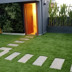 This is another view of the rooftop terrace project, highlighting how the artificial grass, pavers, and planters work together. The design creates distinct zones for walking and relaxing, all while maintaining a cohesive, modern aesthetic.
