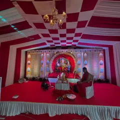 This image shows a wide view of a large-scale Ganpati mandap. I built a multi-level stage with full carpeting, a decorative backdrop, and a checkered fabric ceiling to accommodate a large idol and many devotees.
