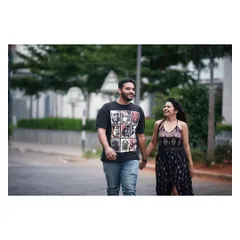 A simple walk down a residential street becomes a beautiful photo opportunity. This candid shot captures a sweet, everyday moment of connection between the couple.