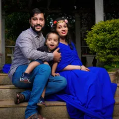 A relaxed family portrait on a set of park stairs. Including older children in the maternity shoot is a wonderful way to make them feel part of the special journey.