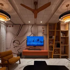 This living room is our love letter to postmodernism, where we designed everything from the furniture to the custom abstract wallpaper. The space combines a bold orange media console, a unique ladder-style bookshelf, and a comfortable armchair, creating a room that feels both artistic and livable.