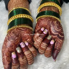 This is one of my favorite engagement sets. I created custom initial nail art with 'N' and 'P' for the couple, combined with a beautiful pink and gold glitter ombré. This design works perfectly with the intricate mehndi and traditional green and gold bangles.