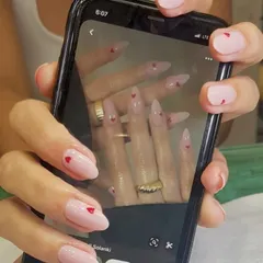 You dream it, I create it. This client brought in an inspiration photo of delicate heart nail art on a sheer pink base, and I brought it to life. I love collaborating with you to create your perfect custom nail design.