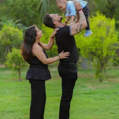 The joy on a child's face when they are lifted high in the air is priceless. Outdoor sessions give us the space to capture these dynamic and energetic family interactions.