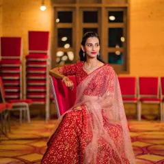 A seated portrait of my client at her brother's engagement. The soft lighting highlights her flawless makeup and the elegant drape of her saree, creating a look of pure sophistication.