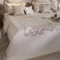 Our Magnolia-Themed Bed Cover Set is a celebration of minimalistic luxury and meticulous craftsmanship. This ensemble features delicate aari and aada embroidery in sophisticated patterns, finished with classic ghimp detailing and soft pleated fringes for a truly timeless bedroom centerpiece.