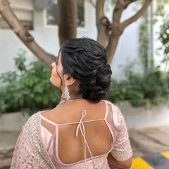 A beautiful profile of the textured low bun, a perfect hairstyle for a reception or engagement party.