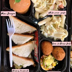 A fun and delicious meal box I created for a movie party. It's filled with treats like a Mini Burger, White Sauce Pasta, Chutney Sandwich, Corn and Cheese Balls, and Mini Pizza.