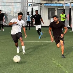 Dribbling the ball during our Primal Patterns football tournament. It was a great day of friendly competition and community building.