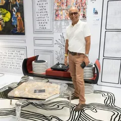 Standing with my sculptural coffee table, which features a natural stone top on a forged steel base.
