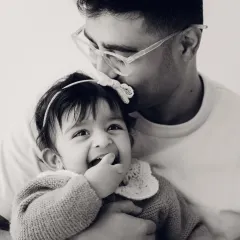 A tender black and white moment between a father and his baby. Removing the color puts all the focus on their expressions and connection.