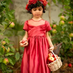 An apple-picking adventure! This outdoor session in an orchard provides a beautiful, natural backdrop for a storybook-themed photoshoot.