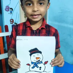 This student is proud to show off the friendly snowman he drew and colored in our class.