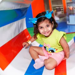A happy toddler peeks out from our colorful crawl tunnel. These tunnels are perfect for little explorers to navigate safely.