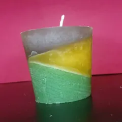 This layered candle features a unique diagonal design with yellow, green, and brown wax. Each one is poured by hand to create this artistic effect.