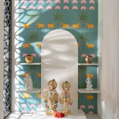 This serene pooja room is a perfect example of using arches to create a sacred and beautiful space. The custom Pichwai-inspired wallpaper with cows and lotuses is framed by a simple white marble arch, creating a divine focal point.
