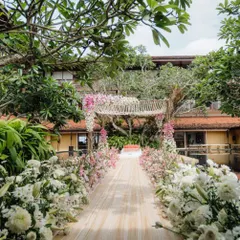 For a bride who wanted to be surrounded by nature, we designed this serene mandap set between trees and water in Sri Lanka. The aisle is lined with soft white and pink florals, leading to an open-air canopy for a pure and peaceful ceremony.