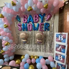This angle highlights the 'BABY' blocks filled with pink and blue balloons, a popular addition for baby showers and gender reveal parties.