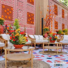 A comfortable lounge area set against a wall featuring traditional Indian block print patterns and jali work. The goal was to provide a beautiful space for guests to relax and soak in the atmosphere.