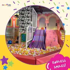 Endless smiles are guaranteed in our play area. This shot captures the pure joy of sliding into our massive, colorful ball pit.