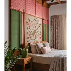 The headboard in this bedroom is the centerpiece, a tapestry of color and texture that extends to the ceiling. We combined pink and green brocade silks with a central hand-painted fabric panel, all framed in rich teak wood. It’s a bold statement that also feels soft and inviting, anchoring the room with artistry.