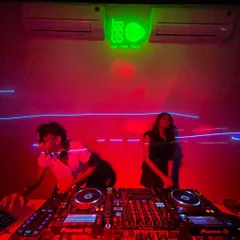 A wide shot of the DJ console at Bonobo during a 'Homie' night. The red lighting and intimate setting create a special vibe.