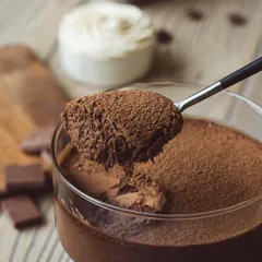 A spoonful of my decadent dark chocolate mousse, showing its light, airy texture and rich cocoa finish. It's pure indulgence.