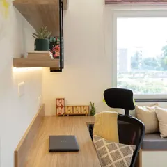 A dedicated study desk with open shelving makes this multi-functional room complete. The design ensures that even with a compact layout, there is a comfortable and well-lit space for work or study.