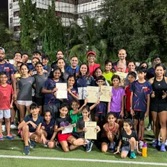 Celebrating a session well done. This is our community of kids and adults, all smiles after pushing their limits together on the field.