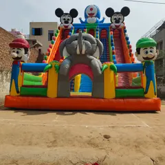 This big size inflatable slide is a mashup of popular characters. It features Mario and Luigi at the front, an elephant archway, and Mickey Mouse and Doraemon at the top.