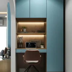 A compact study nook built into an alcove, featuring blue cabinetry and a backlit wooden shelf. It's a perfect example of our smart space planning.