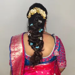 A creative and beautiful braided hairstyle, decorated with small blue and white flowers for a unique touch.