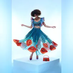 Capturing the playful movement of this floral-printed designer skirt. The studio lighting is set to create a dreamy, floating effect, emphasizing the garment's flow and the intricate details of the poppy design.