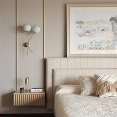 In this master bedroom, I aimed for a calm and sophisticated retreat. The design features a fabric-panelled wall, bespoke fluted bedside tables, and soft, layered textiles to create a warm and inviting atmosphere. The artwork was chosen to complement the serene, neutral tones of the room.