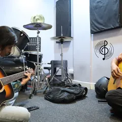 A picture that says it all. This is what our one-on-one coaching looks like: two musicians, sharing a moment, learning and growing together. It's more than a lesson; it's a jam session.