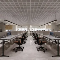 This is a view of the open-plan workstation area in our Defence Colony project. We focused on a clean, organized layout with a neutral color palette and linear pendant lighting to create a bright and productive environment for the team.